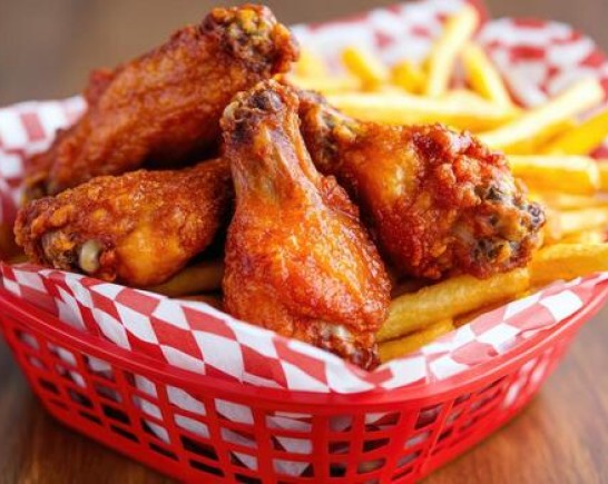 deliciously crispy chicken wings served with golden fries in a vibrant basket photo