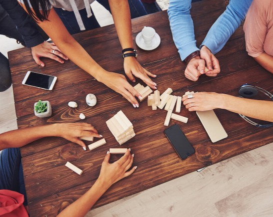 group of friends playing Jenga