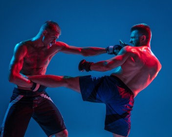 mma two professional fighters punching boxing isolated blue wall neon