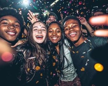 a group of young people at a party taking a selfie photo